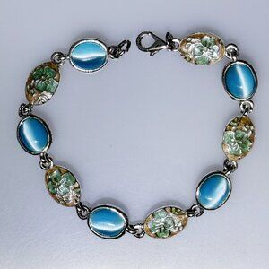 Silver tone bracelet with enamel and fiber optic cabochon links, blues
